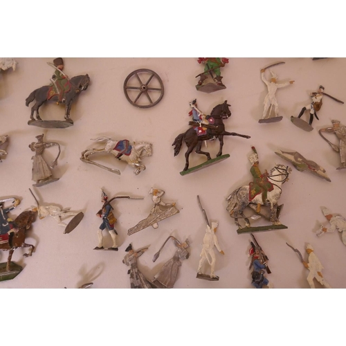 46 - A collection of over seventy early flat back toy soldiers including infantrymen, cavalry, cannon etc... 