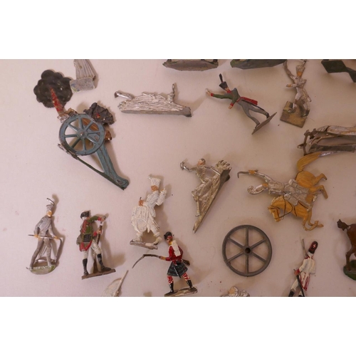 46 - A collection of over seventy early flat back toy soldiers including infantrymen, cavalry, cannon etc... 