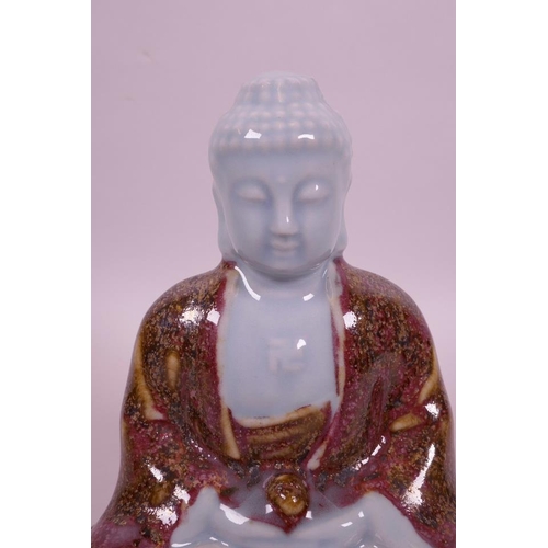 5 - A Chinese powder blue ground porcelain figure of Buddha in red robes, 6½