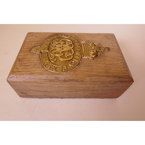 51 - A wooden paperweight inset with a finely cast brass 'Order of the Garter' coat of arms, 6