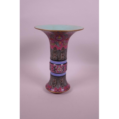 58 - A Chinese gu shaped polychrome porcelain vase with enamelled floral decoration on a pink ground, sea... 