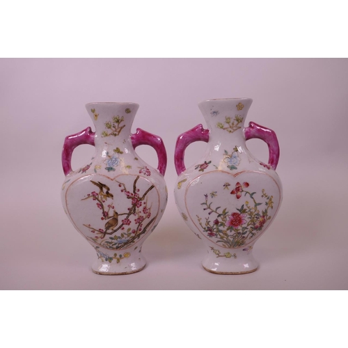 20 - A pair of Chinese polychrome porcelain vases with two handles and heart shaped decorative panels dep... 