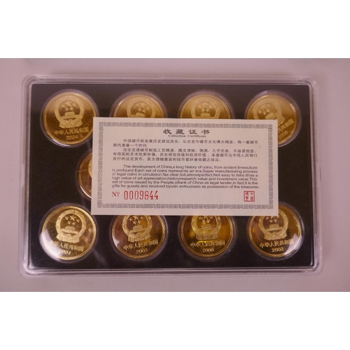 26 - A cased collection of facsimile (replica) Chinese coins commemorating important monuments of China, ... 