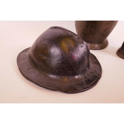 27 - An antique leather bucket, an early C20th leather miner's hat (for a youth) and a leather 'Jack', bu... 