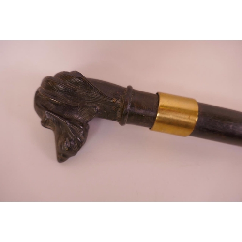 31 - An ebonised faux bamboo walking stick with cast bronze handle in the form of a retriever dog's head,... 