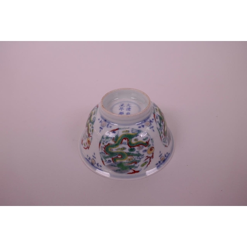 33 - A Chinese doucai porcelain rice bowl decorated with a dragon chasing the flaming pearl, 6 character ... 