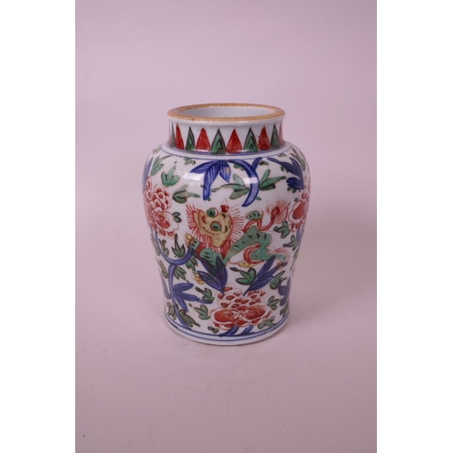 18 - A Chinese wucai pottery vase, decorated with a kylin amongst flowers, 7