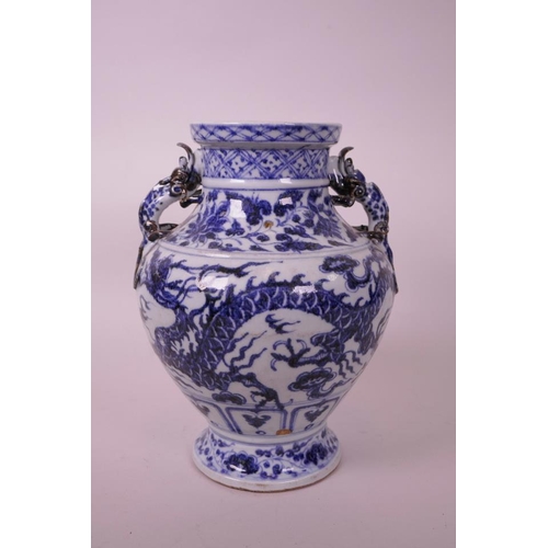 25 - A Chinese blue and white pottery vase, with two dragon handles and painted twin dragon decoration, f... 