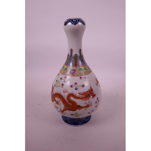 29 - A Chinese polychrome porcelain garlic head shaped vase decorated with two dragons chasing the flamin... 