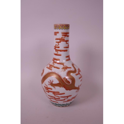 30 - A Chinese polychrome porcelain bottle vase, decorated with a red and gilt dragon chasing the flaming... 