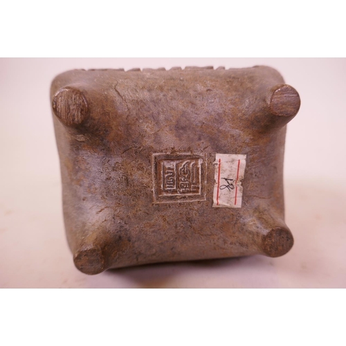 34 - An Eastern bronze censer with two handles and Islamic calligraphic script to side, impressed mark to... 