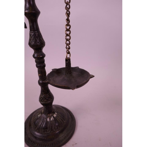 42 - An Indian patinated bronze hanging oil lamp, in the form of a parrot on its perch, 10½