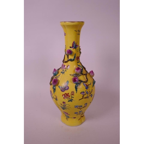 43 - A Chinese yellow ground porcelain vase with a lobed body, decorated with an applied polychrome peach... 