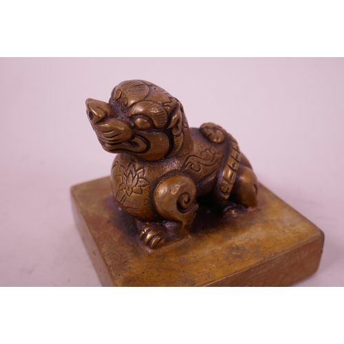 49 - A Chinese square form bronze seal with a kylin knop, 3