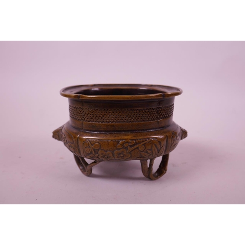 61 - A Chinese bronze censer on tripod bamboo style feet, with a lobed rim and lion mask handles, 5