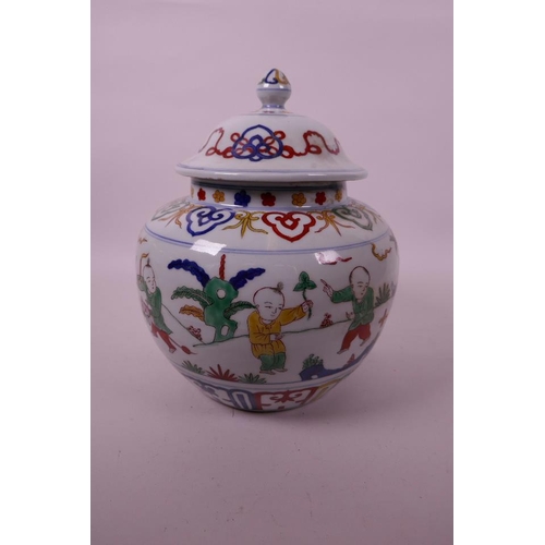 17 - A Chinese wucai porcelain jar and cover decorated with children in a garden, 6 character mark to bas... 