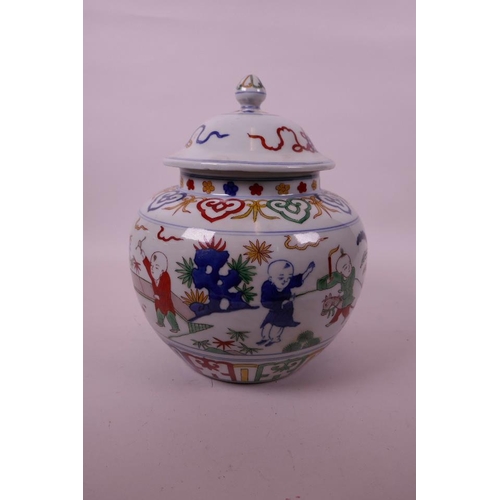 17 - A Chinese wucai porcelain jar and cover decorated with children in a garden, 6 character mark to bas... 