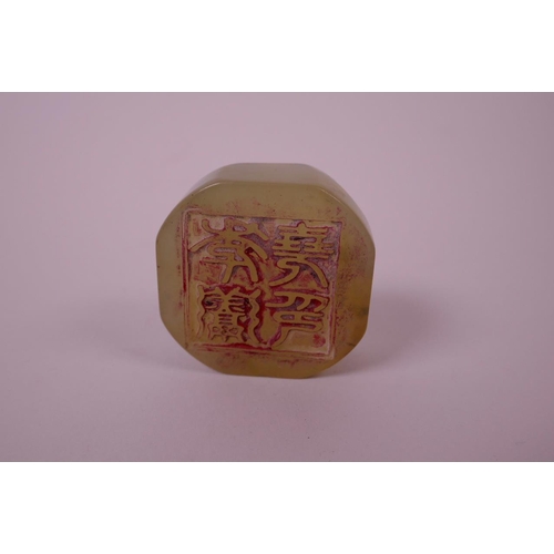 23 - A Chinese green hardstone seal with carved dragon decoration to top, 2