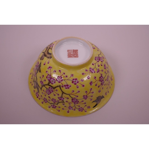 25 - A Chinese yellow ground porcelain rice bowl with polychrome enamelled decoration of birds in a prunu... 