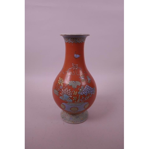 27 - A Chinese peach ground porcelain vase with enamelled decoration of a floral arrangement, seal mark t... 