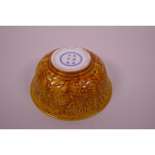 3 - A Chinese yellow ground porcelain rice bowl with raised dragon decoration, 6 character mark to base,... 