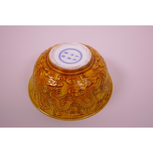 3 - A Chinese yellow ground porcelain rice bowl with raised dragon decoration, 6 character mark to base,... 