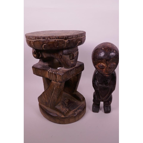 31 - An African wooden stool carved as a squatting figure, 12