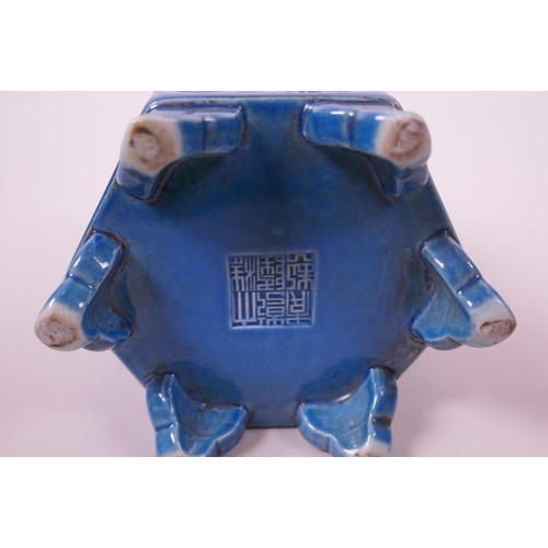 33 - A Chinese blue ground hexagonal brush pot with raised decorative panels depicting dragons and phoeni... 