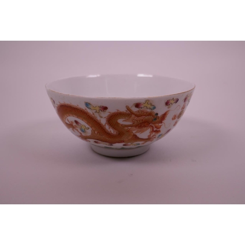 40 - A Chinese polychrome porcelain rice bowl decorated with blue and red dragons chasing the flaming pea... 