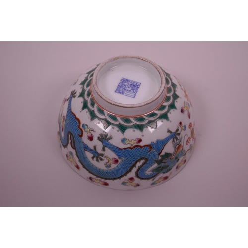 40 - A Chinese polychrome porcelain rice bowl decorated with blue and red dragons chasing the flaming pea... 