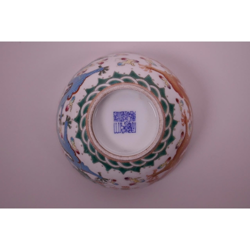 40 - A Chinese polychrome porcelain rice bowl decorated with blue and red dragons chasing the flaming pea... 