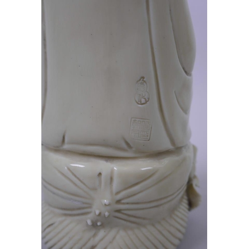 53 - A Chinese blanc de chine porcelain Quan Yin holding a ruyi and seated on a lotus throne, impressed m... 