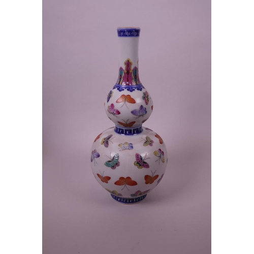 55 - A Chinese polychrome porcelain double gourd vase with all over enamel butterfly decoration, seal mar... 