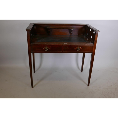 1220 - An Arts and Crafts mahogany writing table with galleried back, pierced ends and two frieze drawers, ... 