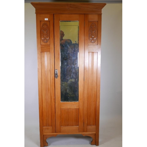 1226 - A Victorian satinwood wardrobe with single mirrored door and carved decoration, 31