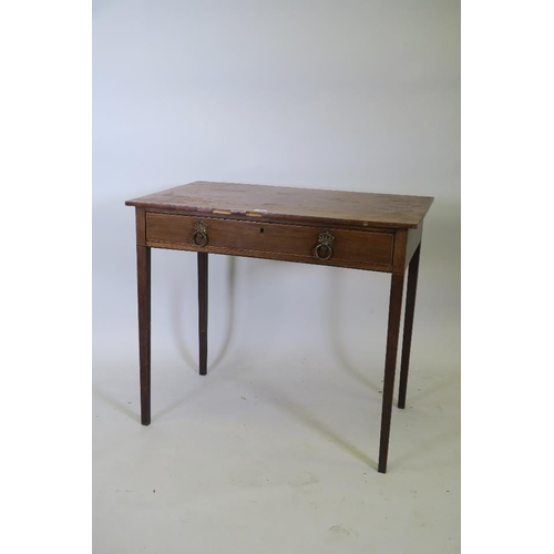 1235 - An early C19th mahogany single drawer side table, with ring handles, raised on square tapering suppo... 