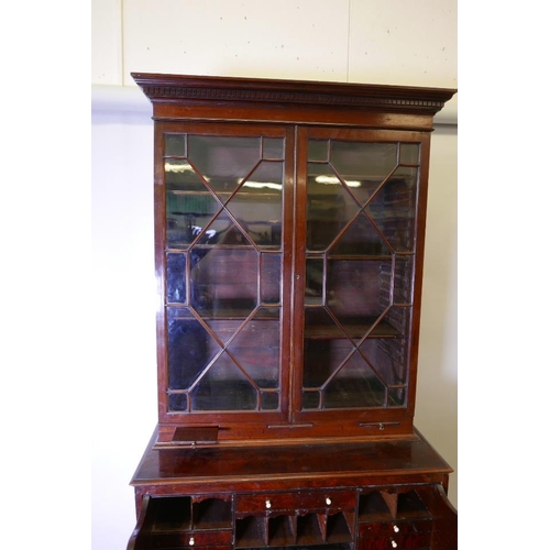 1236 - A George III mahogany secretaire bookcase, the upper section with dentil moulded cornice over two as... 