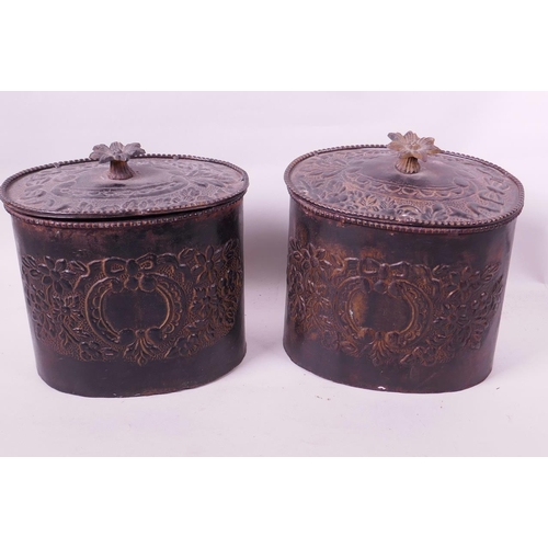 1 - A pair of vintage metal canisters with embossed flower and swag decoration and cast flower handles, ... 