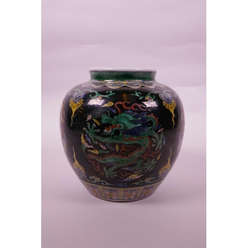 108 - A Chinese famille verte porcelain jar with enamel dragon decoration on a black ground, 6 character m... 