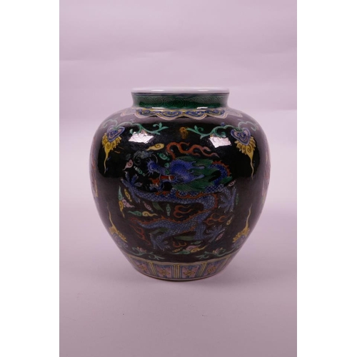 108 - A Chinese famille verte porcelain jar with enamel dragon decoration on a black ground, 6 character m... 