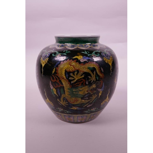 108 - A Chinese famille verte porcelain jar with enamel dragon decoration on a black ground, 6 character m... 