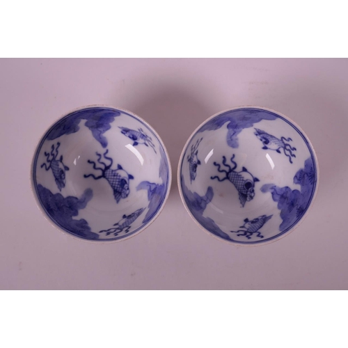 110 - A pair of Chinese polychrome porcelain tea bowls, decorated with women in an interior scene, the bow... 