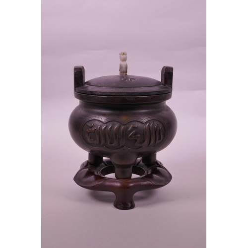 113 - A Chinese bronze censer on tripod supports with a carved hardwood stand and cover, calligraphy to si... 