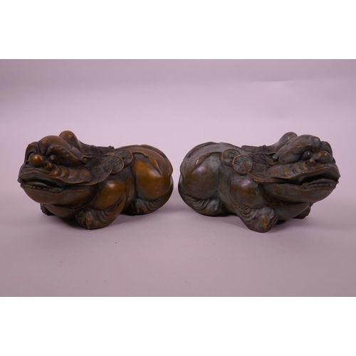 118 - A pair of Chinese filled bronze kylin with green patina, impressed 4 character mark to base, 6½