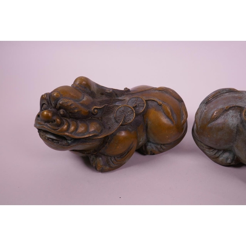 118 - A pair of Chinese filled bronze kylin with green patina, impressed 4 character mark to base, 6½