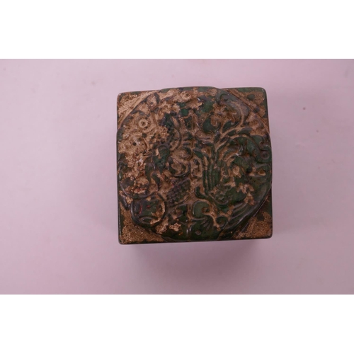 121 - A Chinese green hardstone seal with carved dragon and phoenix decoration to top, 2