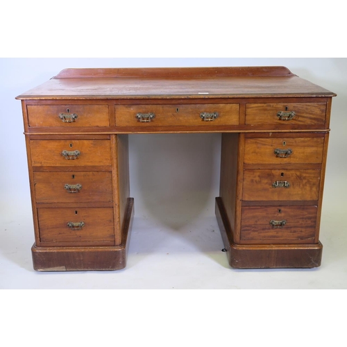 1216 - A C19th mahogany nine drawer pedestal desk, 48