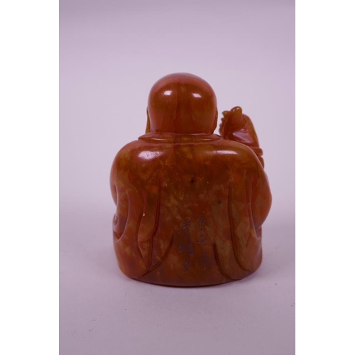 123 - A Chinese carved amber soapstone seal in the form of Buddha, 3½