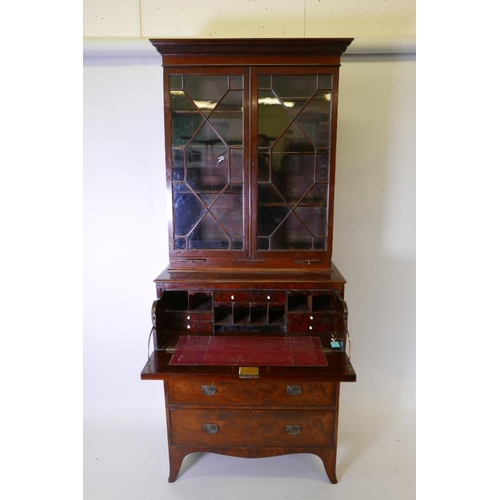 1236 - A George III mahogany secretaire bookcase, the upper section with dentil moulded cornice over two as... 