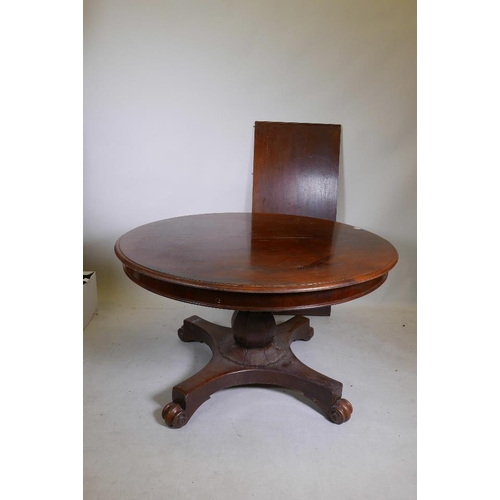 1237 - A C19th mahogany draw leaf dining table, raised on a shaped column and quadruple platform base with ... 